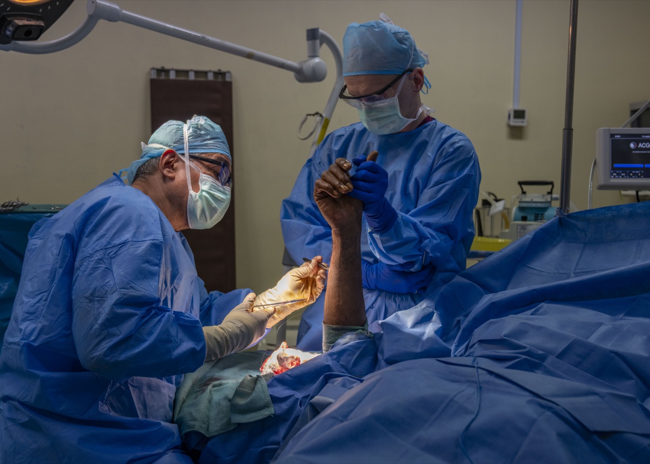 Two surgeons concentrating on the operative field during an orthopedic procedure